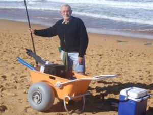 Tom Standing by Wheeleez Beach Cart Tom Standing by Wheeleez Beach Cart